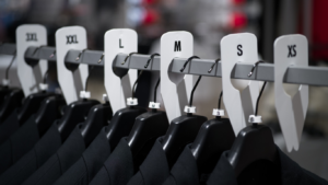 Rack dividers for organized apparel displays by Mark Bric Sizers in a retail store setting.